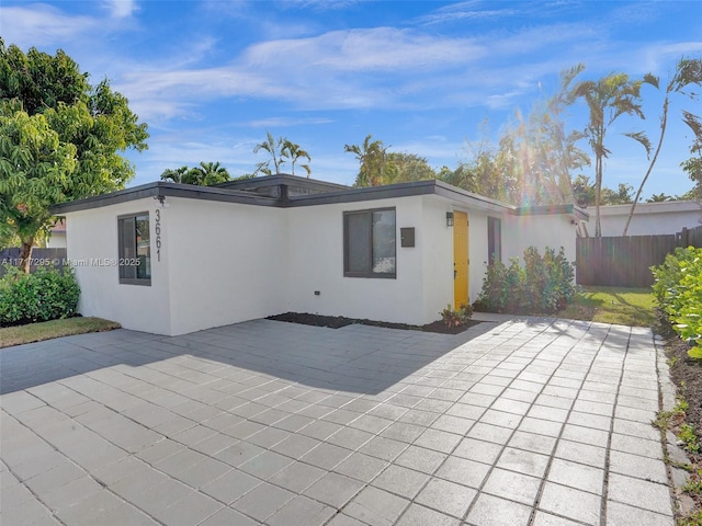 rear view of property featuring a patio area