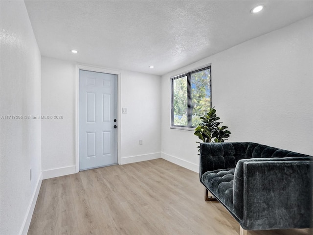 sitting room featuring a textured ceiling and hardwood / wood-style flooring