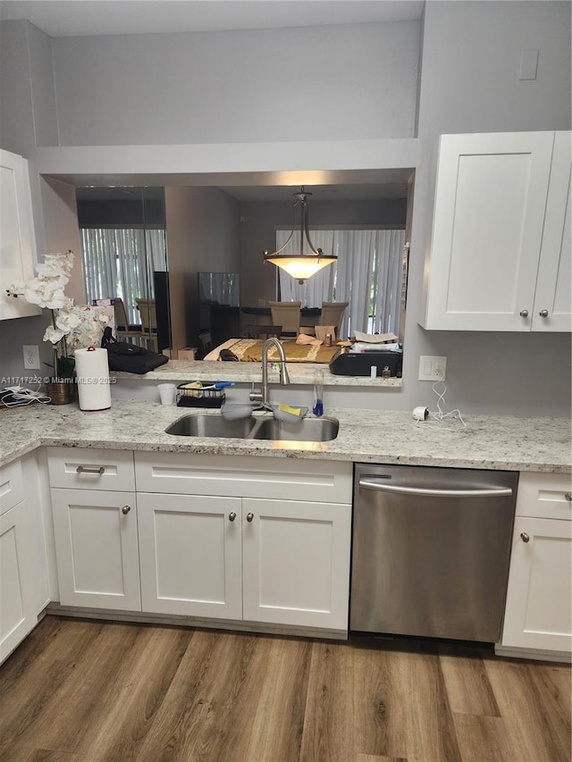 kitchen featuring dishwasher, white cabinets, and sink