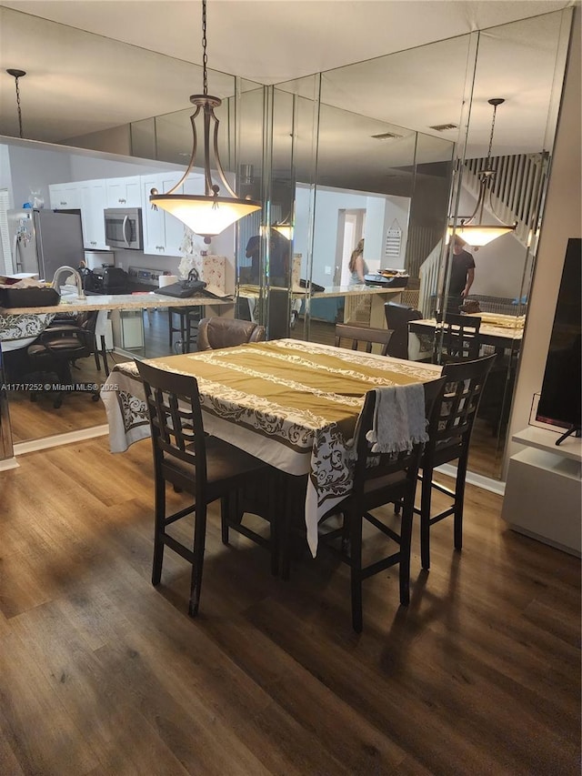 dining area with dark hardwood / wood-style floors