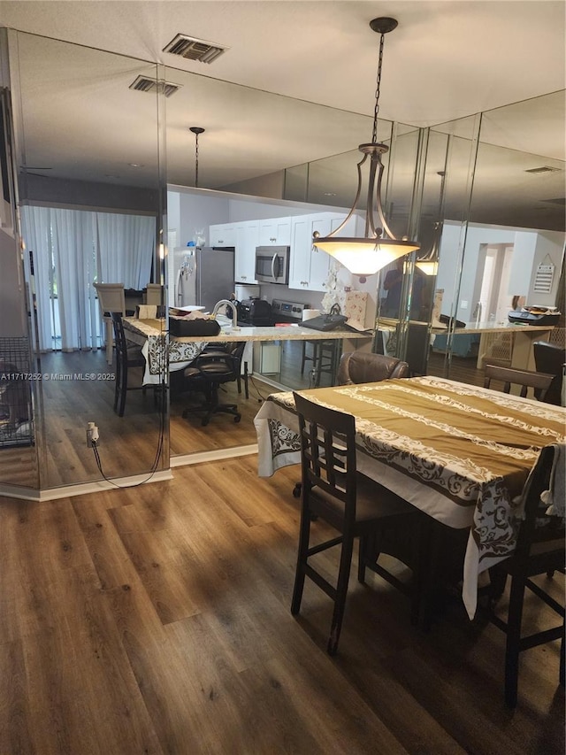 dining room with hardwood / wood-style floors