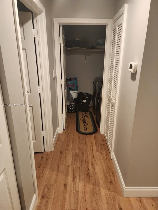 hallway with light hardwood / wood-style flooring