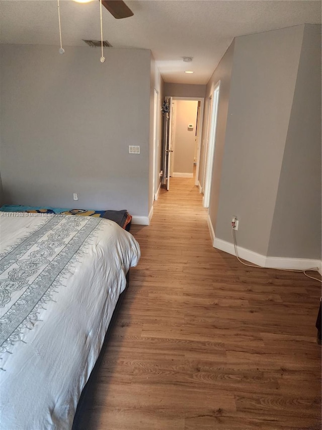 bedroom with ceiling fan and wood-type flooring