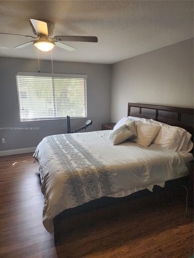 bedroom with dark wood-type flooring and ceiling fan