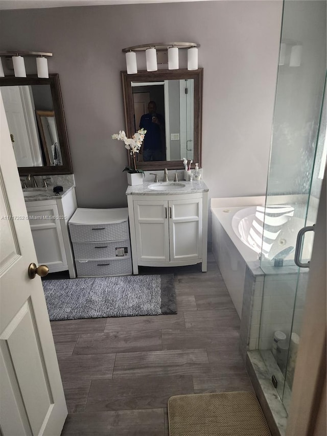 bathroom featuring vanity and independent shower and bath