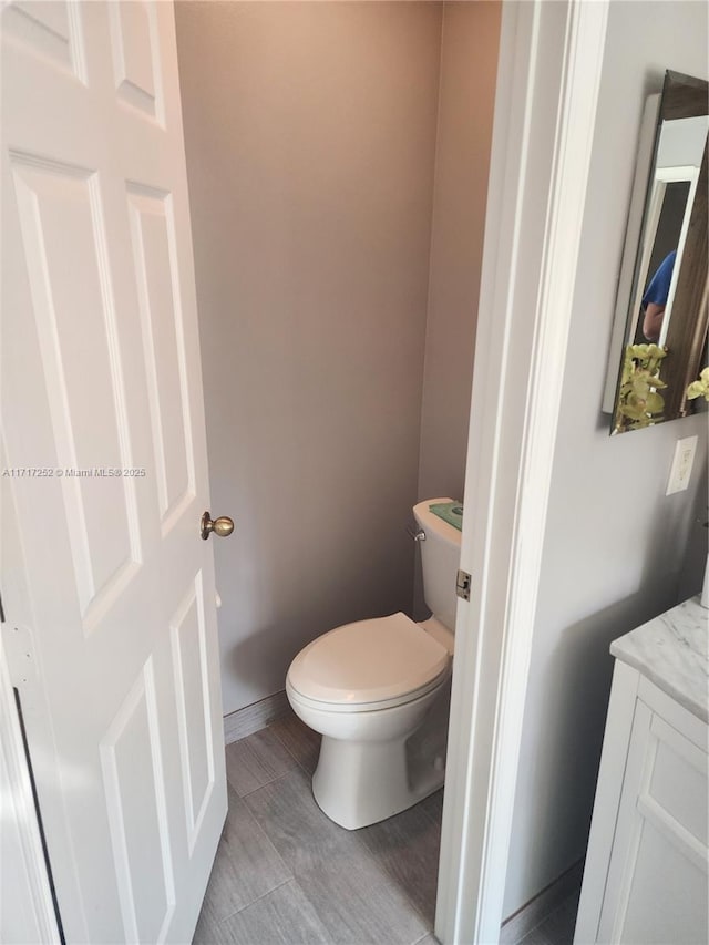 bathroom featuring toilet and vanity