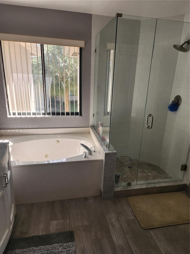 bathroom featuring vanity, independent shower and bath, and hardwood / wood-style flooring