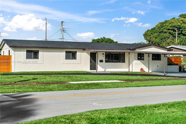 ranch-style house with a front lawn and a carport