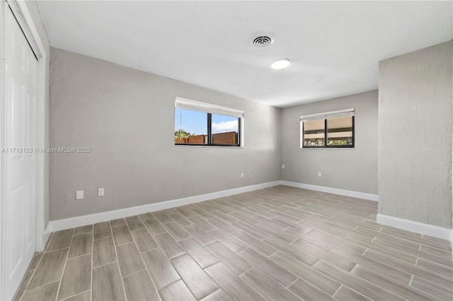 spare room with light hardwood / wood-style floors and a wealth of natural light