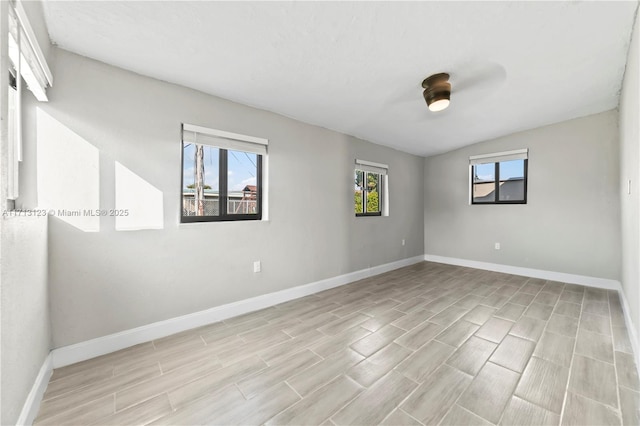 unfurnished room featuring ceiling fan and vaulted ceiling