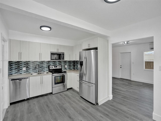 kitchen with sink, stainless steel appliances, and white cabinetry