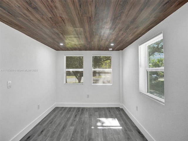 spare room featuring wood ceiling and dark hardwood / wood-style flooring