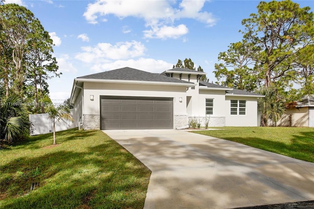 prairie-style home featuring an attached garage, a front lawn, fence, stucco siding, and driveway