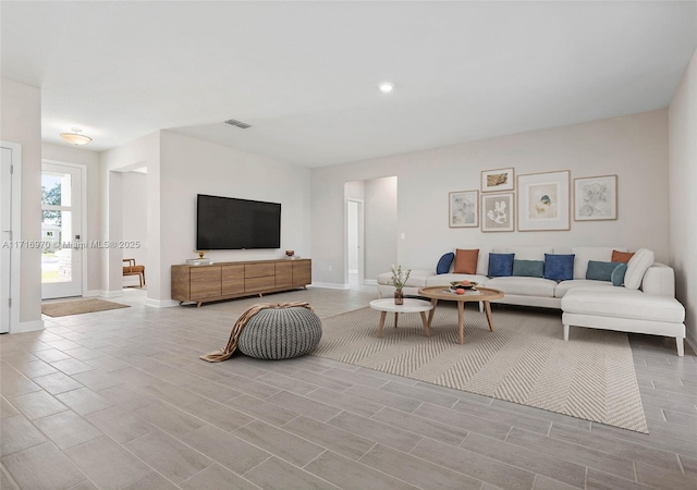 living area featuring visible vents and baseboards