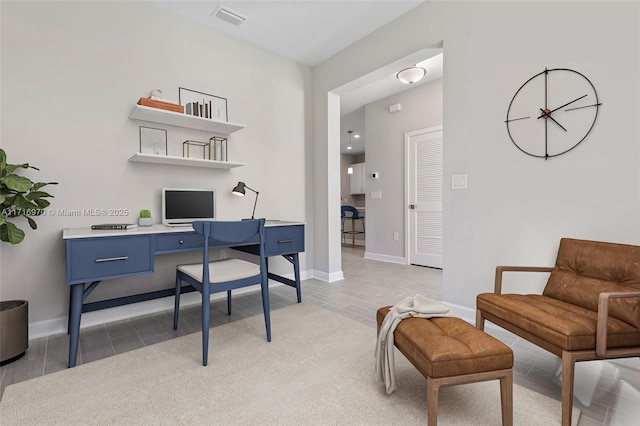 office space featuring visible vents and baseboards