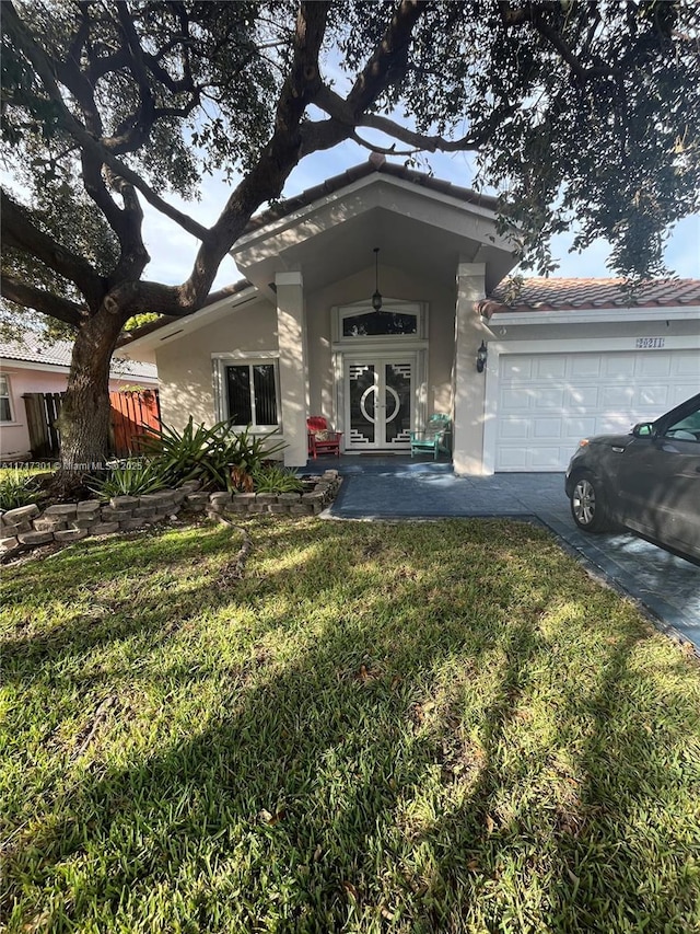 view of front facade with a garage and a front lawn