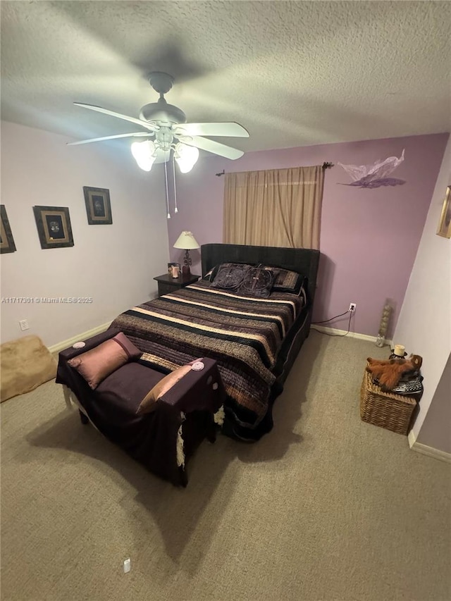 bedroom with a textured ceiling, ceiling fan, carpet, and baseboards