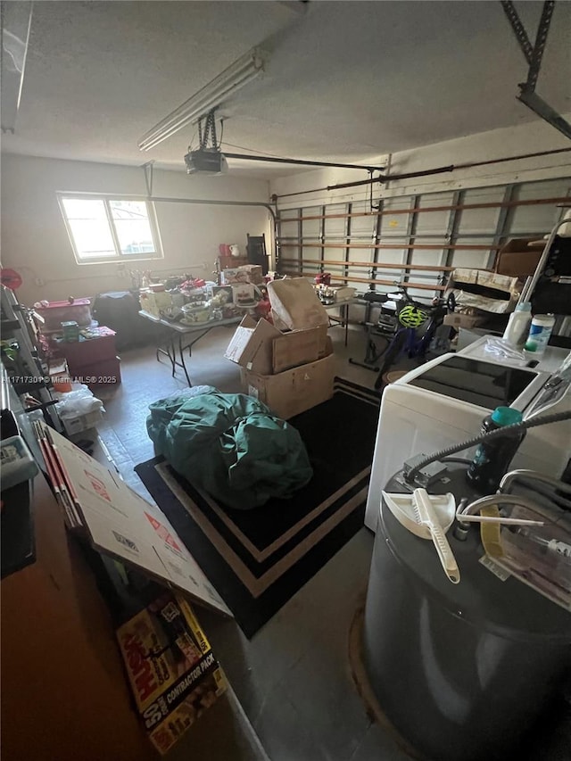 garage featuring a garage door opener and washer / clothes dryer