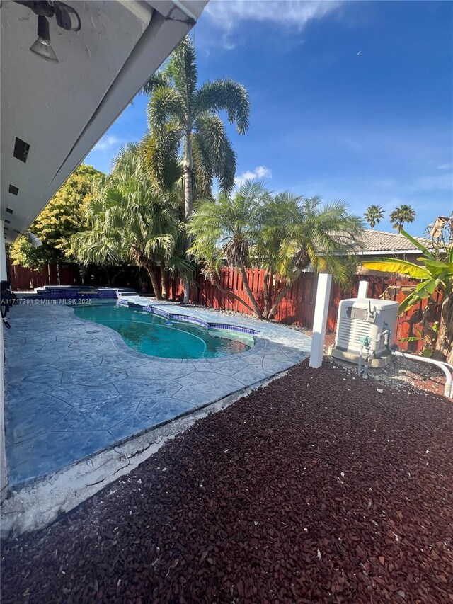 view of pool featuring an in ground hot tub