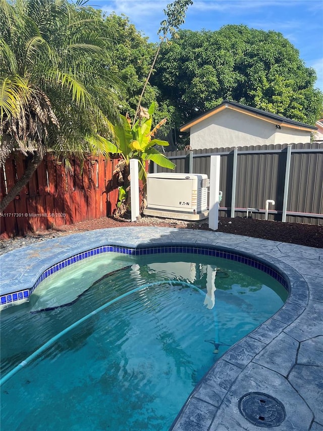 view of swimming pool with a fenced backyard and a fenced in pool