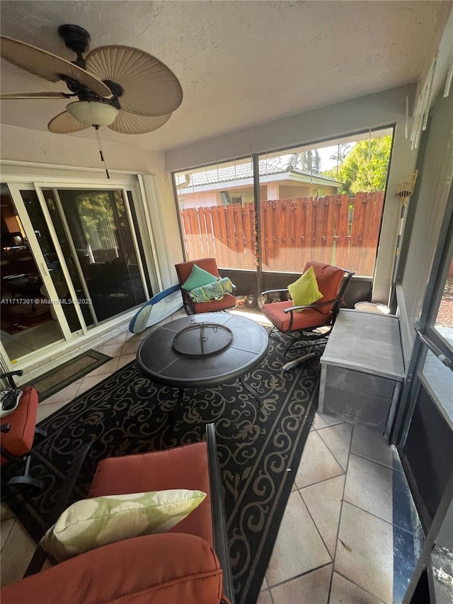 sunroom featuring a healthy amount of sunlight and ceiling fan