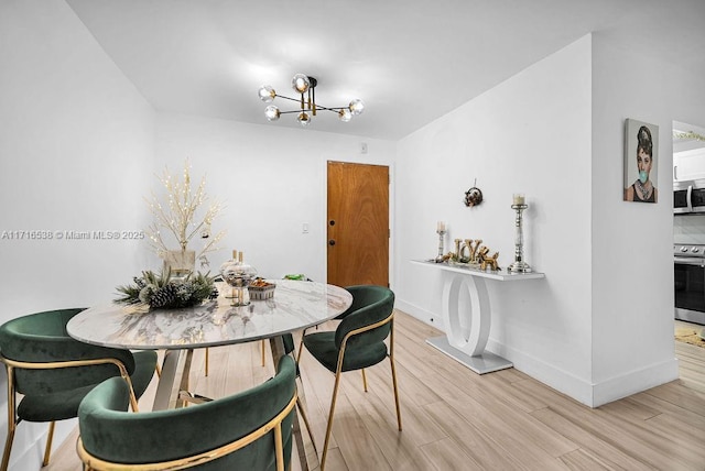 dining space with wood-type flooring and a notable chandelier