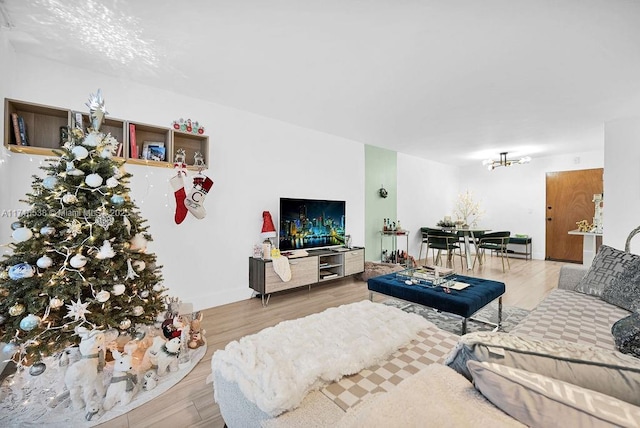 living room with hardwood / wood-style floors and an inviting chandelier