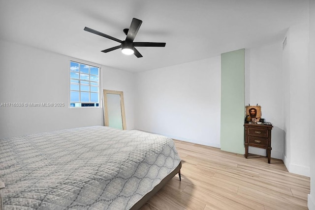 bedroom with light hardwood / wood-style floors and ceiling fan