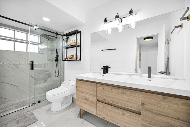 bathroom featuring vanity, toilet, and a shower with door