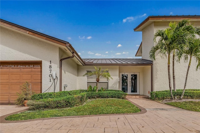 property entrance with french doors and a garage