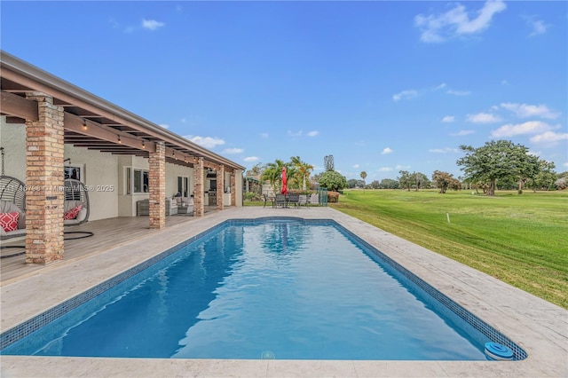 view of swimming pool featuring a yard and a patio