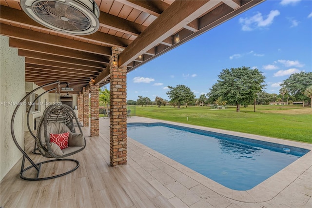 view of swimming pool featuring a yard, a patio, and ceiling fan