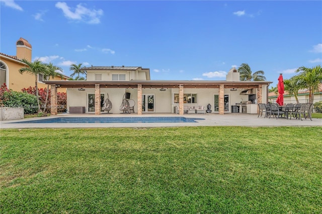 back of house featuring a lawn, ceiling fan, area for grilling, and a patio area