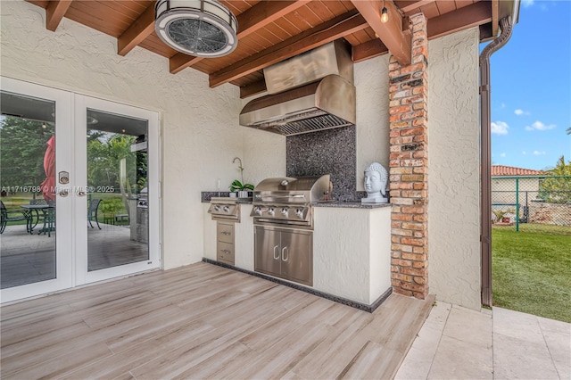 view of patio / terrace featuring a grill, area for grilling, french doors, and a wooden deck