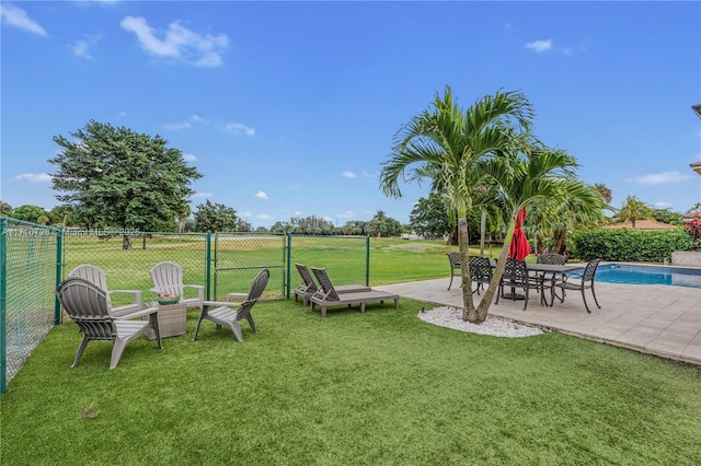 view of yard featuring a patio area and a fenced in pool