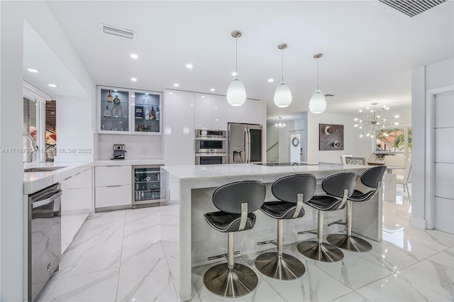 kitchen with white cabinetry, sink, stainless steel appliances, wine cooler, and pendant lighting