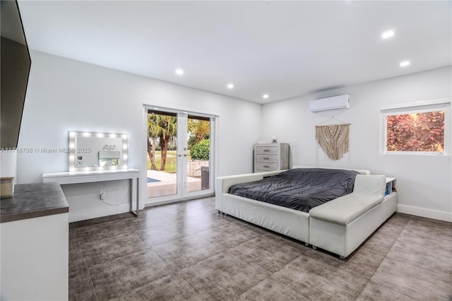 bedroom with a wall mounted air conditioner, access to outside, and concrete floors