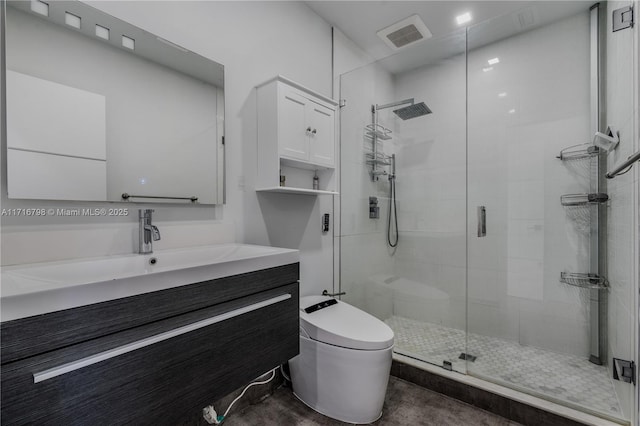 bathroom with vanity, toilet, and an enclosed shower