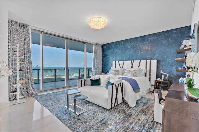 bedroom featuring tile patterned floors, expansive windows, a water view, and access to exterior