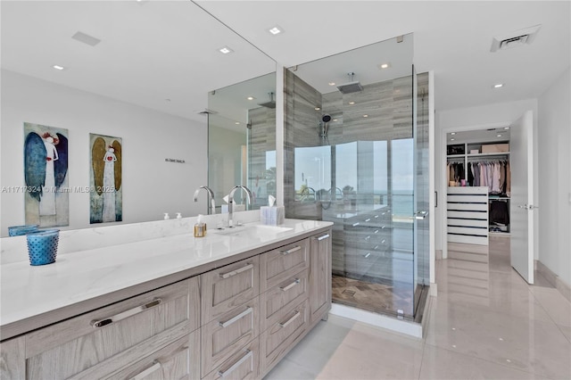 bathroom featuring vanity and a shower with shower door