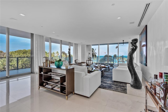 living room featuring expansive windows and light tile patterned flooring