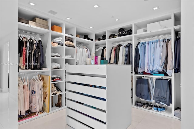 spacious closet with light tile patterned floors