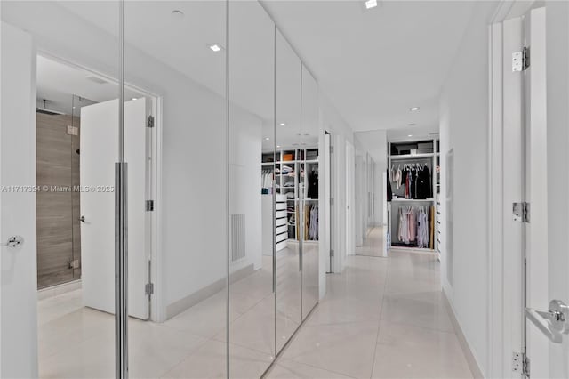 hall featuring light tile patterned floors