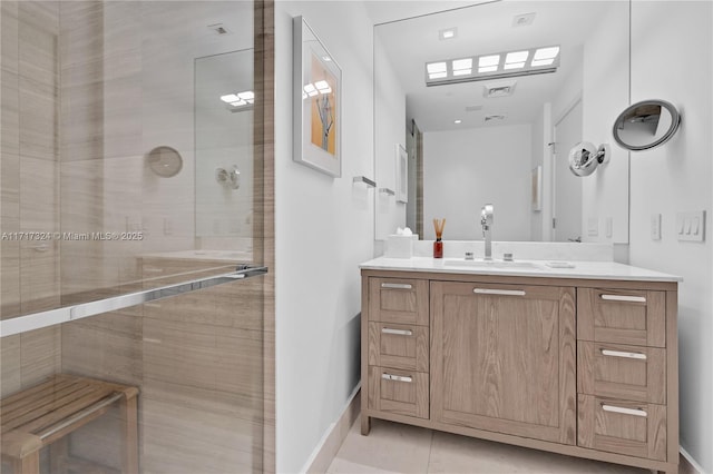 bathroom featuring tile patterned flooring, vanity, and a shower with shower door