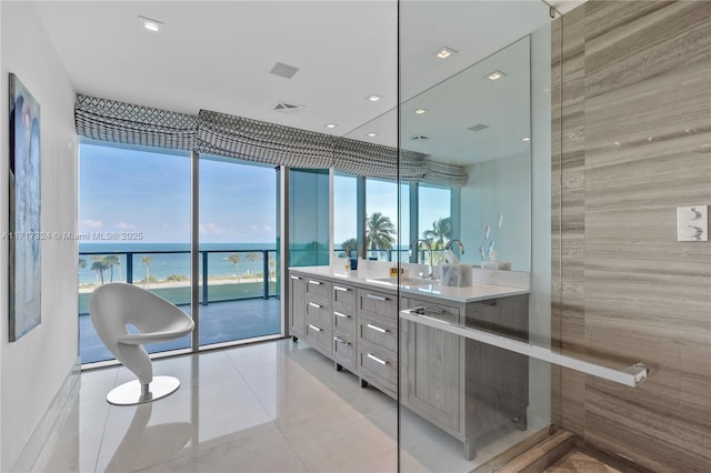 bathroom with tile patterned flooring, vanity, and a water view