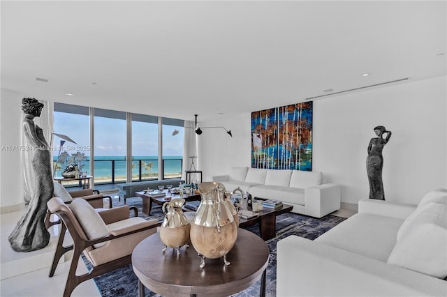 living room with expansive windows and a water view