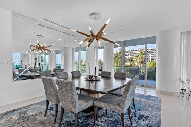 dining space featuring tile patterned flooring, expansive windows, and a notable chandelier