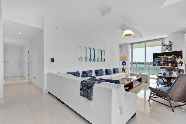 tiled living room with a wall of windows