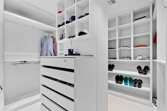 spacious closet with light tile patterned flooring