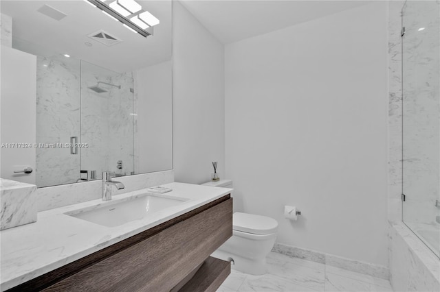 bathroom featuring tiled shower, vanity, and toilet